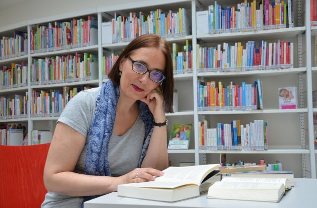 Kursleiterin liest in Büchern